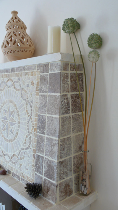 Mosaic tiled fireplace in living area of villa