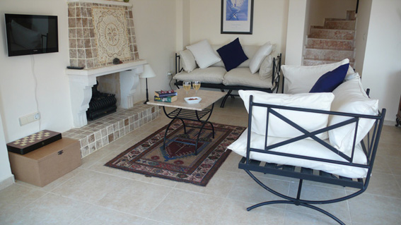 Open plan lounge with sofas in front of fireplace