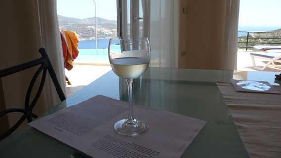Chilled wine and manuscript in open plan living area, with sea views