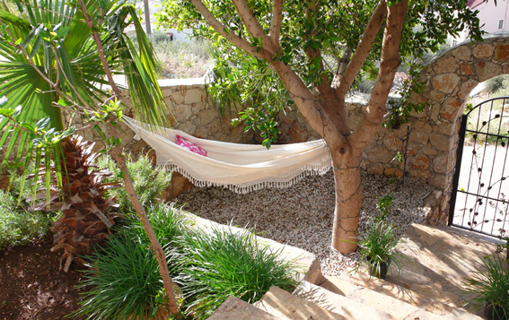 Large hammock under the shade of tree in private garden of rental villa, Kalkan