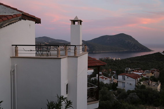 View of sea at sunset from roof terrace