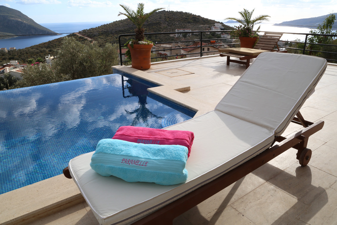 Pool towels and sunlounger by private pool