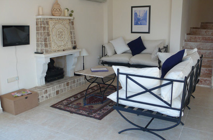 Spacious living area with sofa in front of fireplace