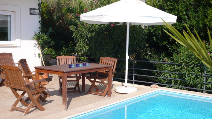 Private terrace and table seating six for al fresco dining, by pool